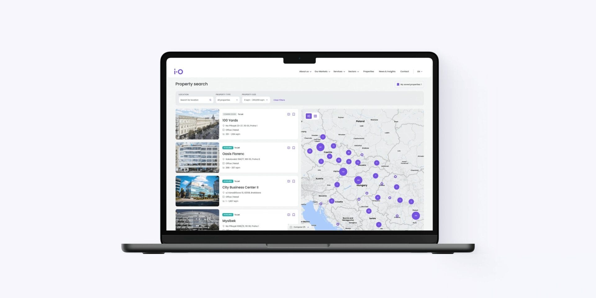 A laptop showing iO Partners property search: filters for location, type and size, a list of office buildings in Prague and Bratislava, and a map of Central Europe with clustered results.