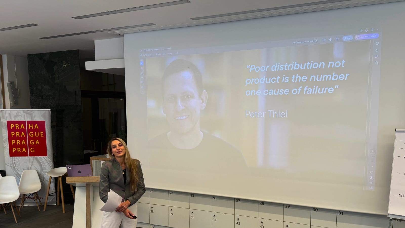 Lucie presenting at a workshop, in front of a projected slide.