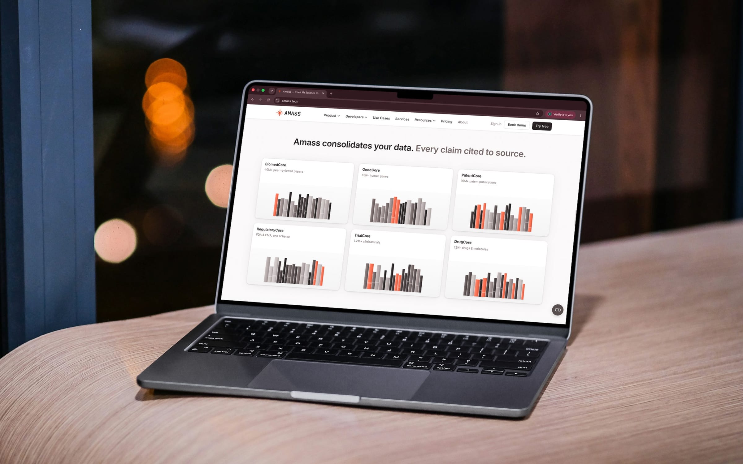 Amass, an AI research product, on a laptop: every claim cited to its source.
