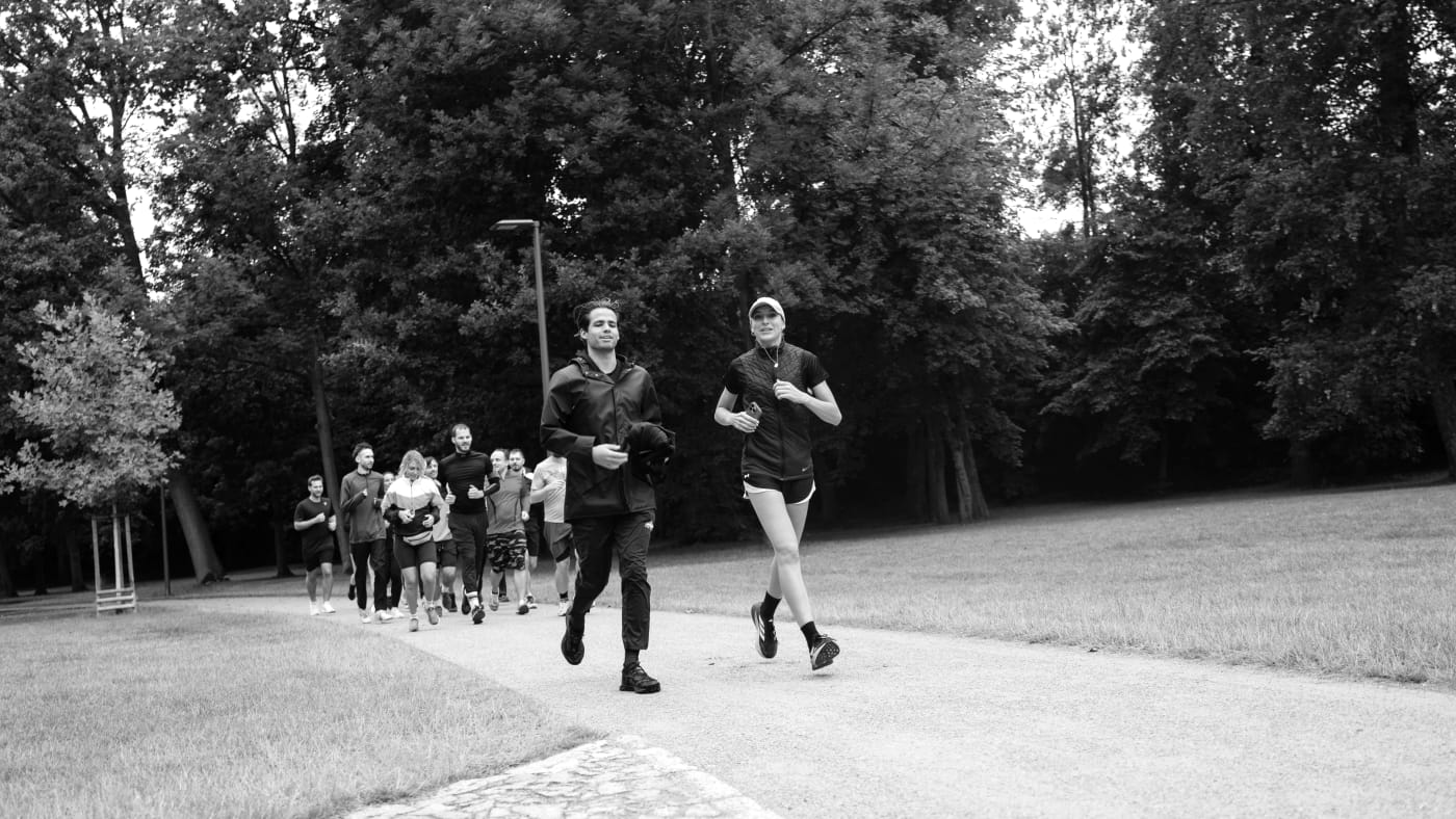 Founders Running Club Prague, co-founded by Lucie Krulich, on a group run through a park.